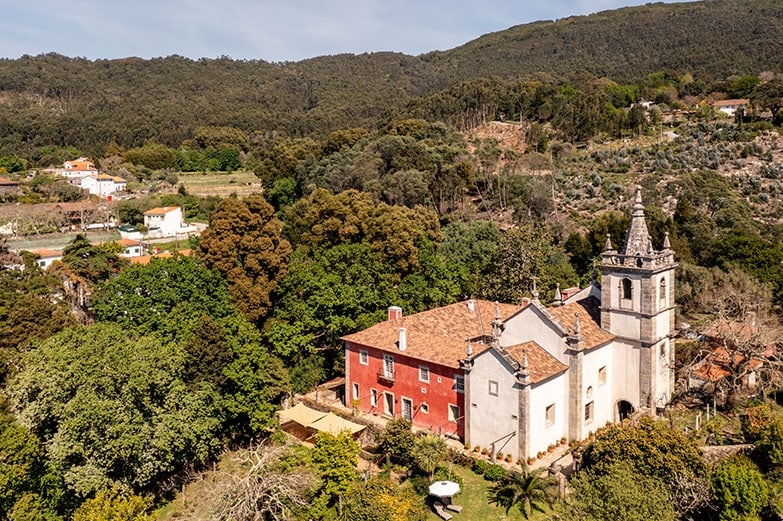 The estate from above, the red house, the church and the mountain behind